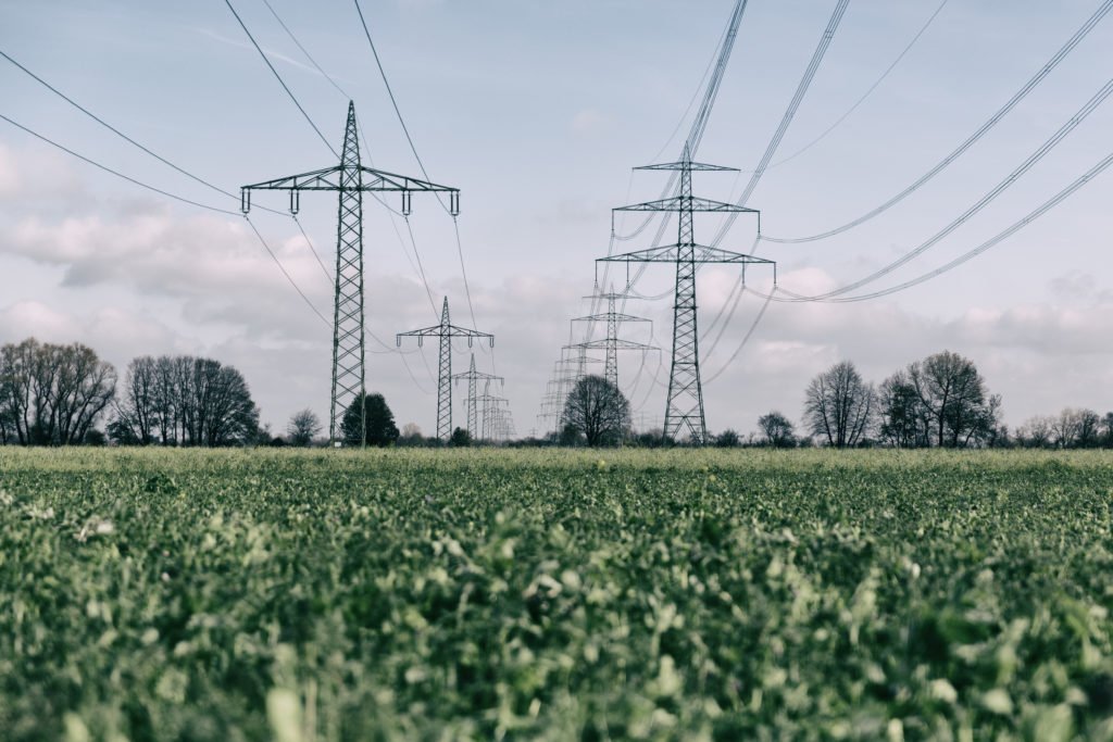 power_pylons_on_green_field power_pylons_on_green_field
